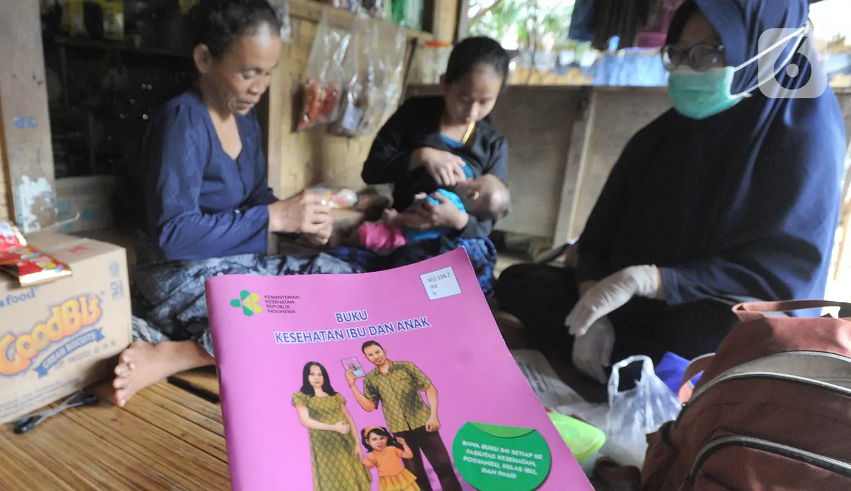 Petugas medis Puskesmas Cisimeut Bidan Pite memeriksa kesehatan bayi saat Posyandu keliling di Kampung Baduy Luar Gazebo, Kanekes, Banten, (Rabu (27/01/2021). Pelayanan kegiatan Posyandu keliling  tersebut sudah Bidan Pite jalani selama 6 tahun. (merdeka.com/Arie Basuki)