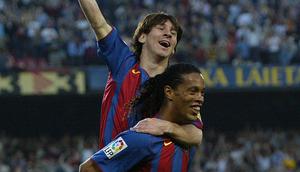 Ronaldinho menggendong Lionel Messi usai memberikan assist untuk gol pertamanya bagi Barcelona. (AFP/Lluis Gene)