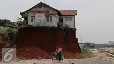 Warga melintas di samping Musala yang masih berdiri di lokasi pembangunan proyek Tol Cinere-Jagorawi di Depok, Jawa Barat, Selasa (1/11). Pembangunan Tol ini masih menyisakan 555 Bidang tanah yang belum dibebaskan. (Liputan6.com/Johan Tallo)
