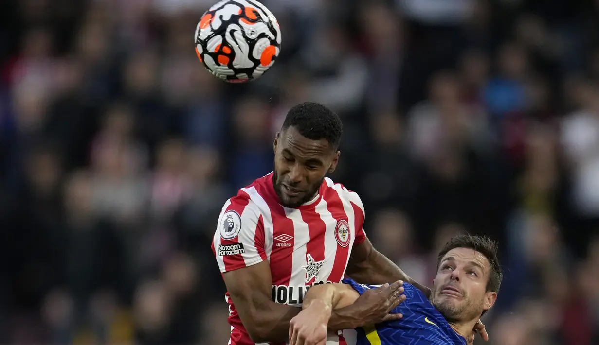 Bek Brentford Rico Henry berebut bola dengan bek Chelsea Cesar Azpilicueta pada matchday kedelapan Liga Inggris di Brentford Community Stadium, Sabtu (16/10/2021) malam WIB. Chelsea menang 1-0 lewat gol Ben Chilwell. (AP Photo/Matt Dunham)