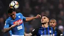 Gelandang Napoli, Allan melompat untuk merebut bola dari pemain Inter Milan Mauro Emanuel Icardi dalam lanjutan Serie A di Giuseppe Meazza, Senin (12/3). Inter Milan  dan Napoli harus puas berbagi angka dengan skor akhir 0-0. (MARCO BERTORELLO / AFP)