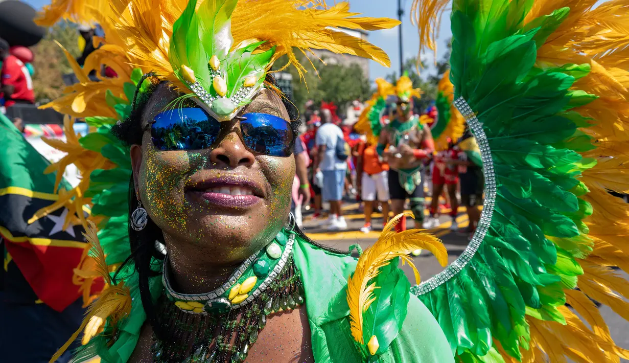 Seorang peserta mengenakan kostum saat berpartisipasi dalam Parade West Indian Day di distrik Brooklyn, New York, Senin (3/9). Komunitas Karibia di New York telah mengadakan perayaan tahunan Karnaval sejak tahun 1920. (AP Photo/Craig Ruttle)