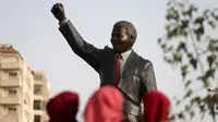 Patung tokoh revolusi dunia asal Afrika Selatan, Nelson Mandela berdiri tegak di kota Ramallah, Palestina, Selasa (26/4). Patung dengan tangan kanan mengepal ke udara itu menjulang dengan ketinggian enam meter dan bobot dua ton. (REUTERS/Mohamad Torokman)