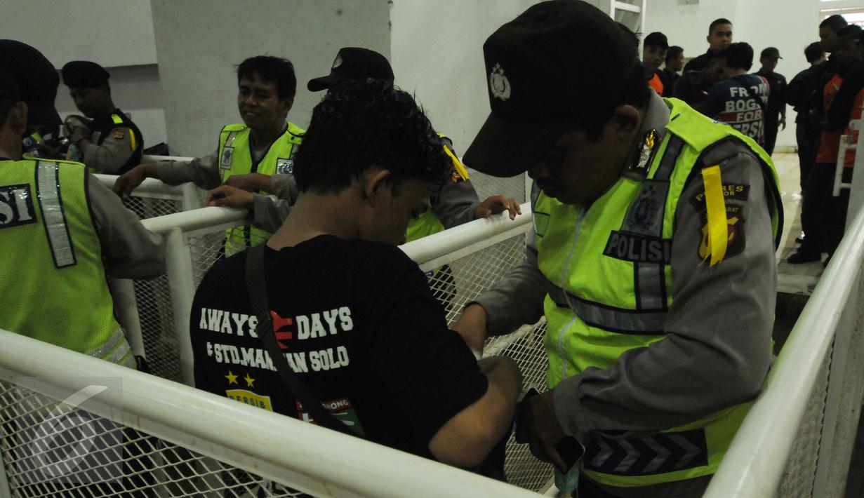 Personel polisi memeriksa suporter yang akan Stadion Pakansari, Kab Bogor, Sabtu (11/3). Jelang laga perebutan tempat ketiga Piala Presiden 2017 antara Semen Padang vs Persib, keamanan Stadion Pakansari diperketat. (Liputan6.com/Helmi Fithriansyah)