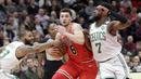Pebasket Chicago Bulls, Zach LaVine, berusaha melewati pebasket Boston Celtics, Marcus Morris, pada laga NBA di Stadion United Center, Selasa (6/3/2018). Celtics menang 105-89 atas Bulls. (AP/Charles Rex Arbogast)