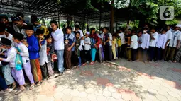 Warga mengantre untuk mendapatkan nasi kota usai melaksanakan Sholat Jumat di Masjid Wihdatul Ummah, Cinere, Depok,Jumat (27/5/2022). Setiap minggunya setelah kegiatan Sholat Jumat lebih dari 700 nasi kotak yang merupakan sumbangan dari donatur jamaah masjid  dan warga sekitar dibagikan kepada warga dalam rangka Jumat Berkah. (merdeka.com/Arie Basuki)