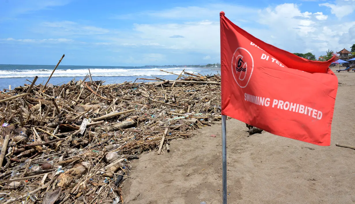 Tumpukan puing dan sampah memenuhi pantai setelah tersapu badai lepas pantai di Batu Belig di Kabupaten Badung, Bali (14/12/2021). Tumpukan sampah plastik dan puing tersebut mencemari bibir pantai. (AFP/Sony Tumbelaka)
