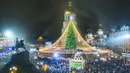 Kerumunan orang merayakan Tahun Baru di sekitar pohon Natal dengan Katedral St. Sofia sebagai latar belakang di Kyiv, Ukraina, Jumat pagi, 1 Januari 2021. Terlepas dari pembatasan karantina COVID-19, banyak orang Ukraina menikmati Tahun Baru di luar ruangan acara. (AP Photo/Efrem Lukatsky)