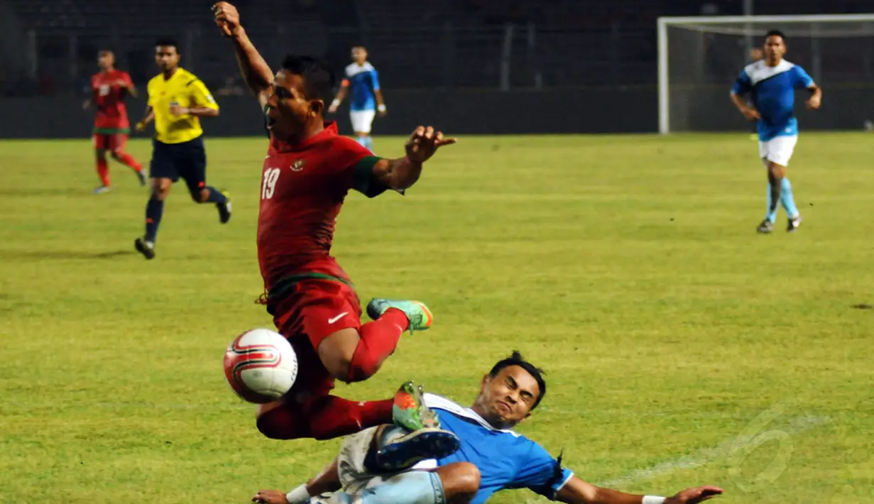 TA Mushafry (Indonesia-atas) dijatuhkan bek Aff All Star, M Aidil Zafuan Bin Abdul Radzak saat berlaga di Stadion GBK Jakarta, (11/5/2014). (Liputan6.com/Helmi Fithriansyah)
