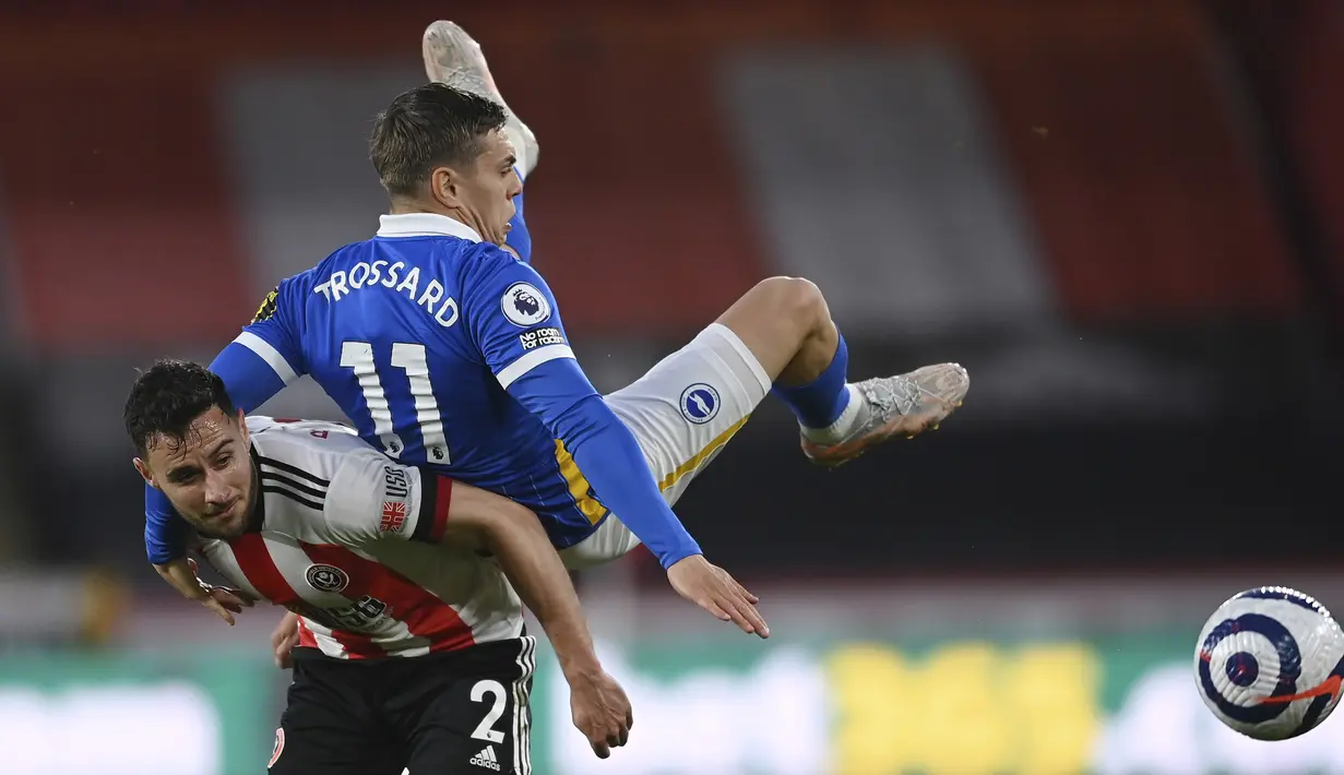 Gelandang Brighton and Hove Albion, Leandro Trossard (atas) berebut bola dengan bek Sheffield United, George Baldock dalam laga lanjutan Liga Inggris 2020/2021 pekan ke-33 di Bramall Lane, Sheffield, Sabtu (24/4/2021). Brighton kalah 0-1 dari Sheffield United. (AP/Laurence Griffiths/Pool)