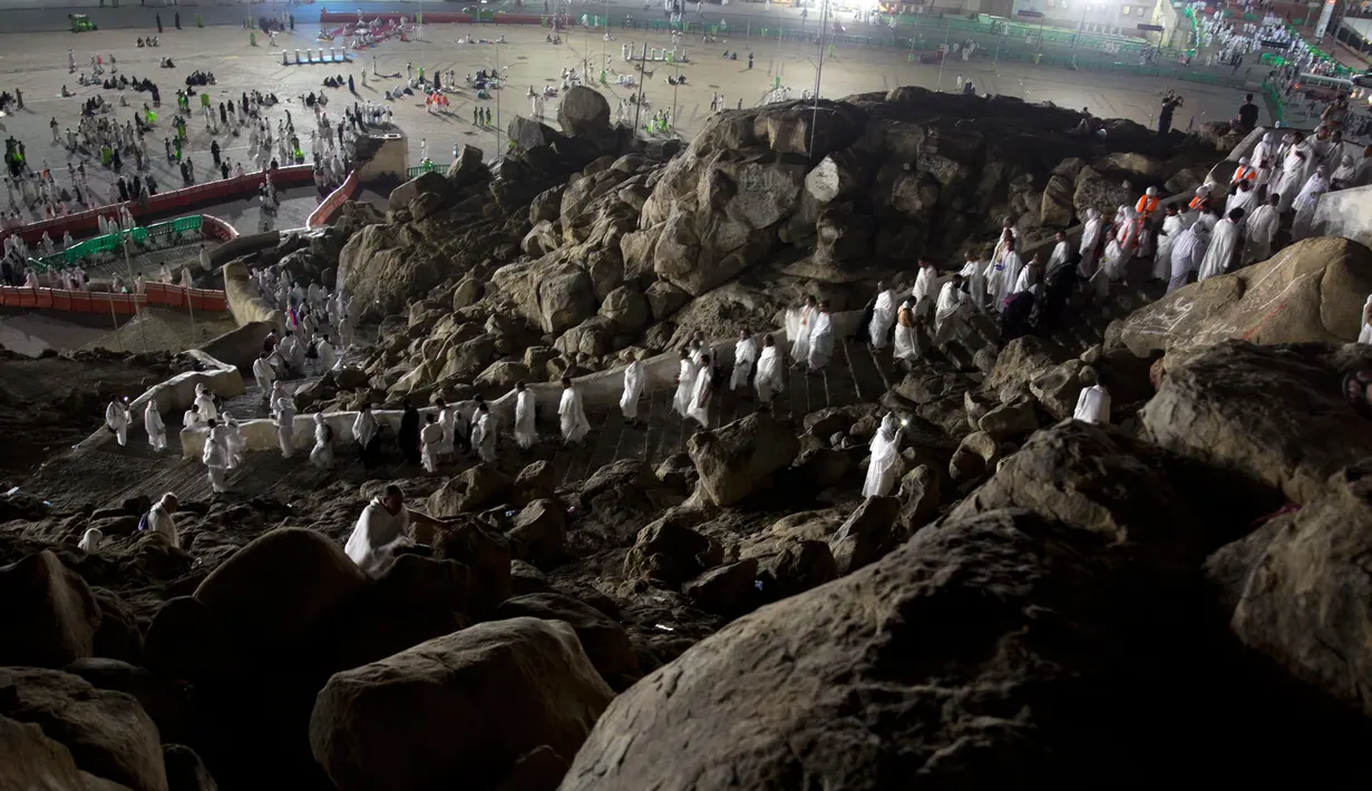 Jemaah calon haji berada di Bukit Jabal Rahmah, saat mereka tiba di Arafah untuk menjalani wukuf di luar kota suci Mekah, Arab Saudi (30/8). Bukit Jabal Rahmah dikenal sebagai bukit kasih sayang. (AP Photo / Khalil Hamra)