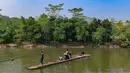 Warga bersama sepeda motornya menyeberangi Sungai Cisadane menggunakan rakit bambu di kawasan Ciseeng, Kabupaten Bogor, Jawa Barat, Kamis (11/6/2026). (merdeka.com/Arie Basuki)