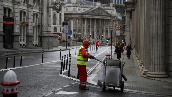 Seorang pembersih jalan bekerja pada pagi pertama penerapan lockdown nasional ketiga di Kota London, Inggris, 5 Januari 2021. Penerapan lockdown nasional ketiga di Inggris berlangsung selama enam minggu. (AP Photo/Matt Dunham)