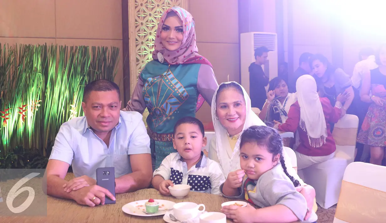 Krisdayanti berpose bersama keluarga saat menghadiri lini busana Lusense KD by Luthy di kawasan Kebon Jeruk, Jakarta, Rabu (5/10). KD mendapat pujian dari Raul Lemos saat tampil dengan hijab. (Liputan6.com/Herman Zakharia)