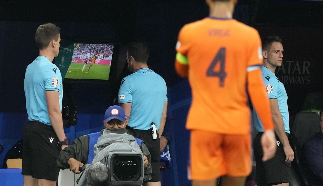 Wasit Felix Zwayer (tengah) memeriksa rekaman VAR sebelum memutuskan memberi hadiah penalti untuk Timnas Inggris saat menghadapi Jerman atas pelanggaran Denzel Dumries terhadap Harry Kane pada laga semifinal Euro 2024 di Westfalenstadion, Dortmund, Jerman, Kamis (10/7/2024). (AP Photo/Frank Augstein)