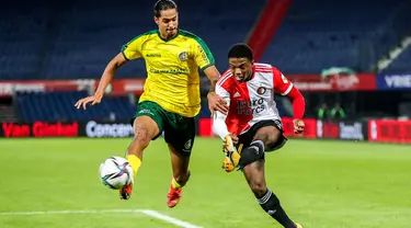 Bek Feyenoord, Tyrell Malacia (kanan) menembak bola dari kawalan pemain Fortuna Sittard, Nigel Lonwijk pada pertandingan Eredivisie Belanda di Feyenoord Stadium de Kuip di Rotterdam pada 5 Desember 2021. Manchester United resmi memboyong Tyrell Malacia dari Feyenoord Rotterdam. (AFP/ANP/Pieter Stam de Jonge)