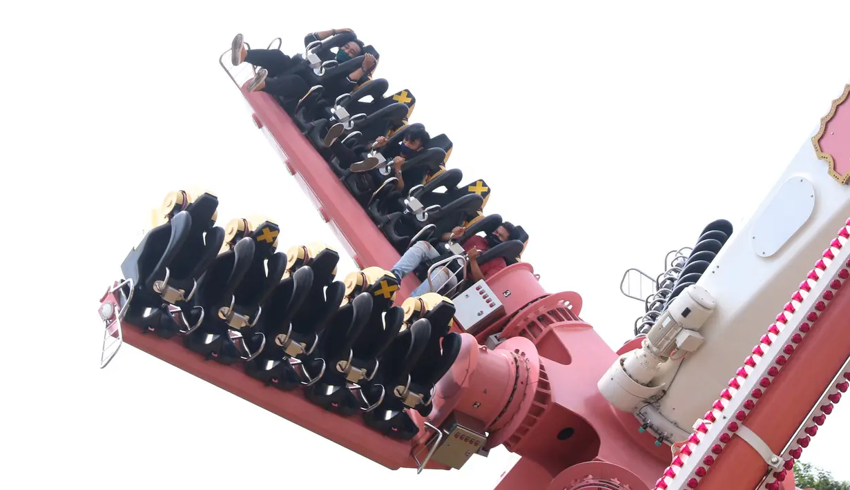Pengunjung mencoba wahana permainan saat berwisata di Dufan, Ancol, Jakarta, Sabtu (20/6/2020). Setelah ditutup selama dua bulan akibat pandemi COVID-19, kawasan rekreasi Taman Impian Jaya Ancol kembali dibuka. (Liputan6.com/Angga Yuniar)