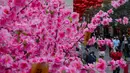 Orang-orang berjalan melewati dekorasi untuk merayakan Tahun Baru Imlek di Hong Kong, Minggu (30/1/2022). Tahun Baru China atau Imlek jatuh pada 1 Februari (AP Photo/Vincent Yu)