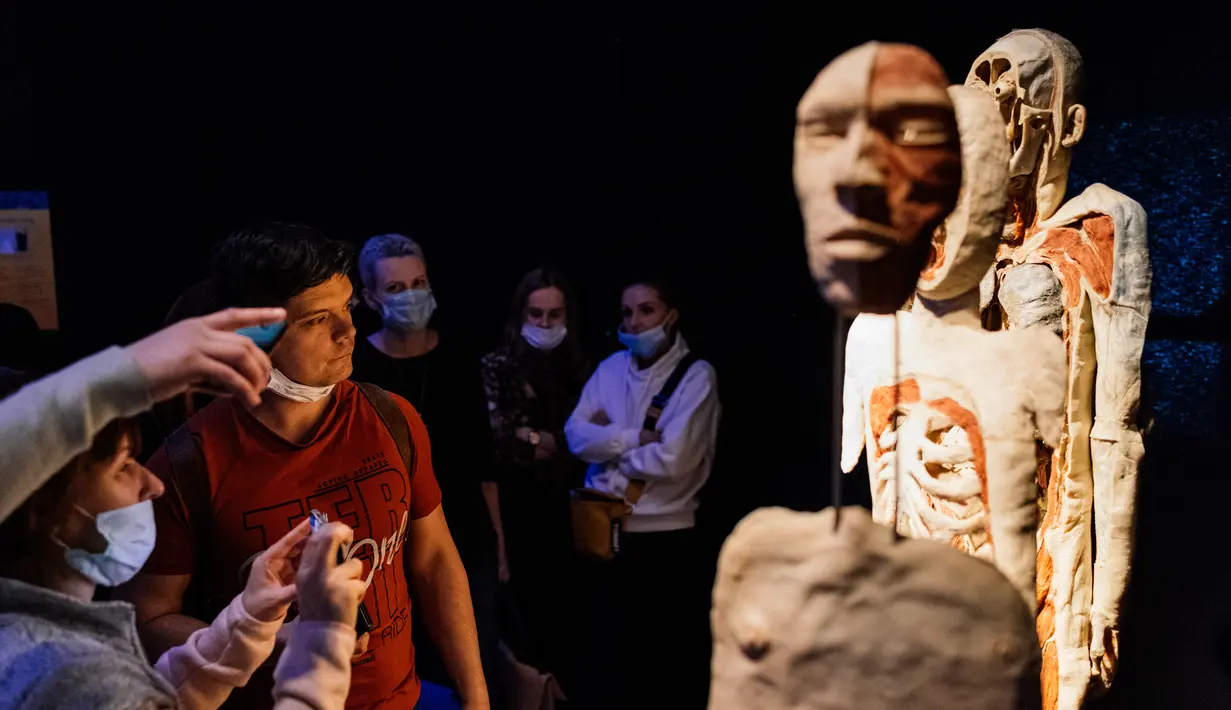 Pengunjung melihat salah satu karya seni yang dipajang dalam pameran anatomi tubuh manusia bertajuk 'Body Worlds' di Moskow, Rusia (24/3/2021). Pameran ini digagas oleh ahli anatomi asal Jerman, Gunther von Hagens. (AFP/Dimitar Dilkoff)