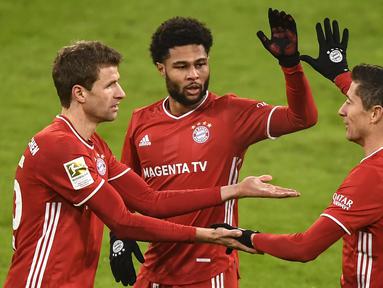 Penyerang Bayern Munchen, Robert Lewandowski, merayakan gol yang dicetaknya ke gawang Wolfsburg pada laga lanjutan Liga Jerman di Allianz Arena, Kamis (17/12/2020) dini hari WIB. Bayern Munchen menang 2-1 atas Wolfsburg. (AFP/Lukas Barth-Tuttas/pool)