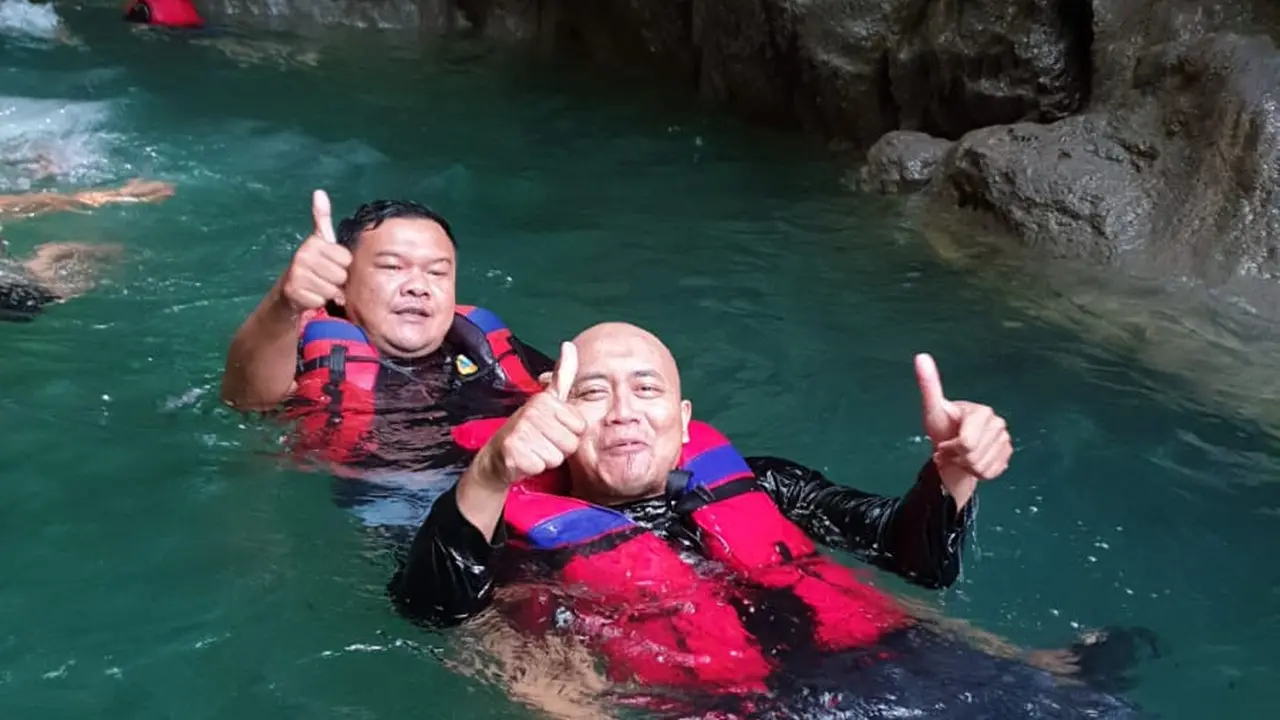 Dua orang pengunjung tengah menikmati sajian alam air jernih kawasan wisata sungai green Citumang, Pangandaran. (Liputan6.com/Jayadi Supriadin)