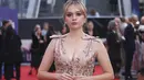 Aimee Lou Wood berpose di depan fotografer saat tiba untuk pemutaran perdana film 'Living' selama Festival Film London 2022 di London, Minggu, 9 Oktober 2022. Dia menaikkan tinggi badannya dengan sepasang sepatu hak bertali yang serasi. (Photo by Vianney Le Caer/Invision/AP)