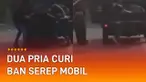Sebuah rekaman video menunjukkan detik-detik dua pria mencuri ban serep mobil.