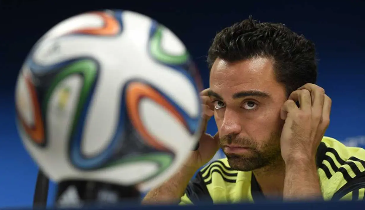 Xavi menyebut bahwa Spanyol tidak perlu mengubah gaya bermain yang sudah diterapkan dalam beberapa tahun terakhir. Mengubah gaya bermain Spanyol, menurut Xavi, adalah sebuah kesalahan, Brasil, Jumat (13/6/2014) (AFP Photo/LLUIS GENE).