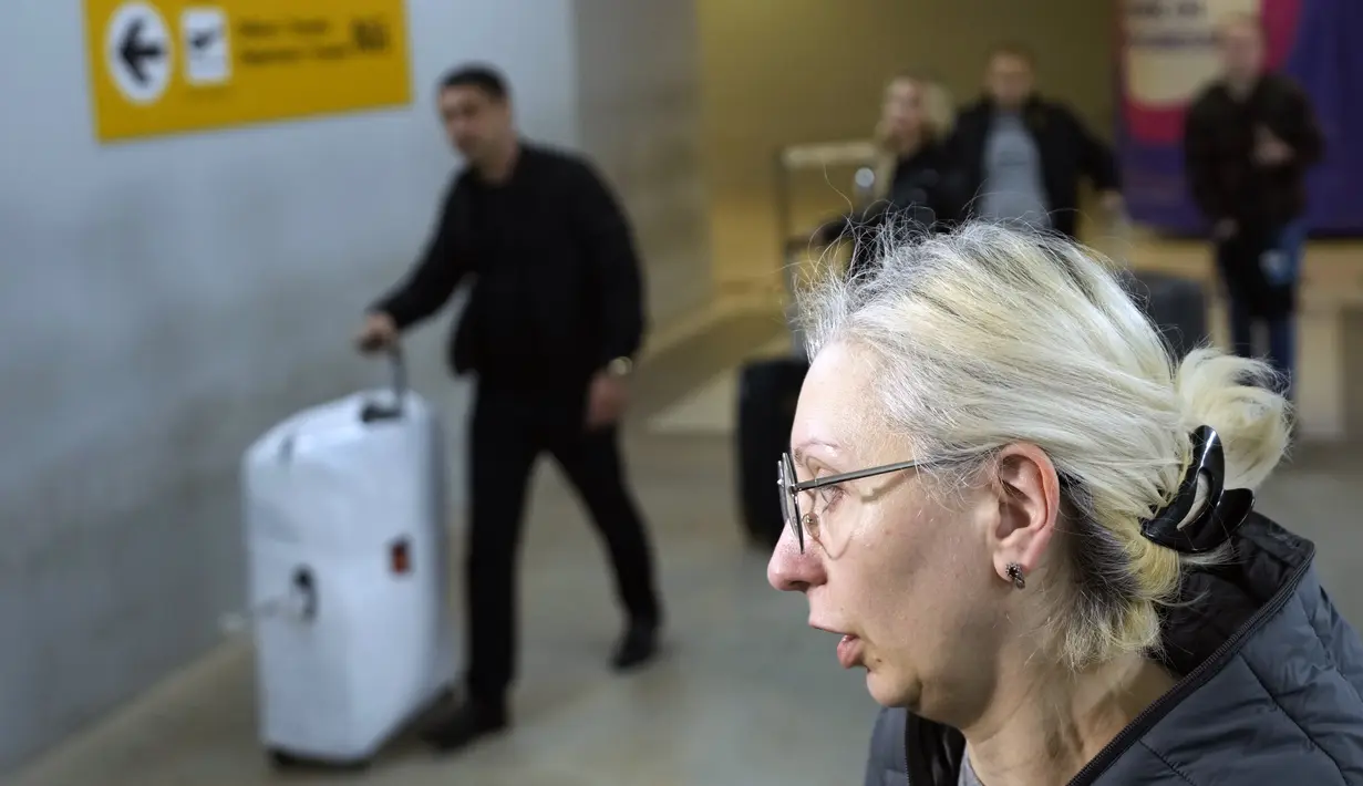 Yulia, penumpang dari penerbangan Moskow-Belgrade yang dioperasikan oleh Air Serbia, berbicara kepada media di bandara di Beograd, Serbia, Rabu (21/9/2022). Pengumuman Putin, yang dibuat dalam pidato televisi pada Rabu (21/9/2022) pagi menimbulkan kekhawatiran bahwa beberapa pria yang tergolong di usia pertempuran tidak akan diizinkan meninggalkan Rusia. (AP Photo/Darko Vojinovic)