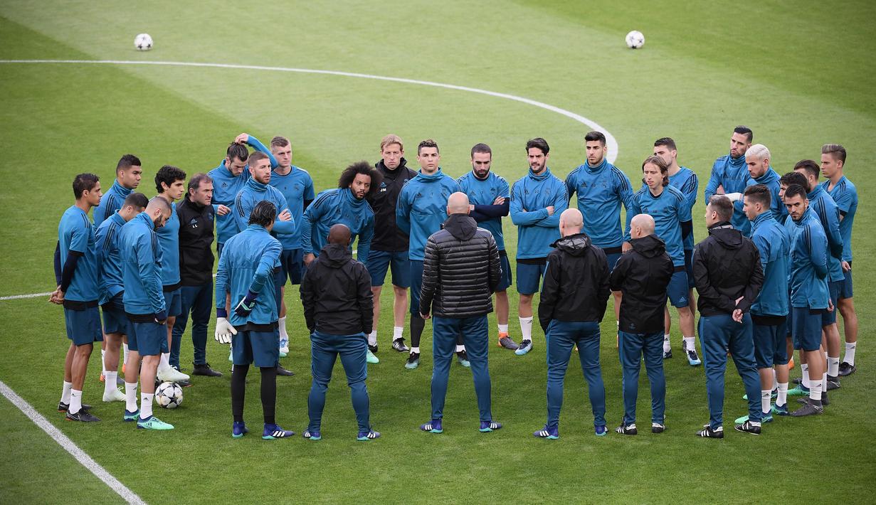 Para pemain mendengarkan arahan dari pelatih Real Madrid, Zinedine Zidane, saat latihan jelang laga Liga Champions di Stadion Allianz, Turin, Senin (2/4/2018). Real Madrid akan berhadapan dengan Juventus. (AFP/Marco Bertorello)