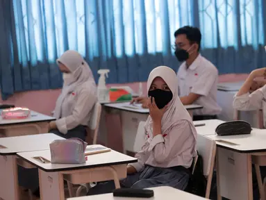 Siswa mengikuti uji coba pembelajaran tatap muka (PTM) terbatas di SMAN 1 Kota Tangerang, Banten, Senin (6/9/2021). Dinas Pendidikan Provinsi Banten uji coba PTM di SMA di Kota Tangerang secara terbatas dengan sistem bergiliran serta menerapkan protokol kesehatan ketat. (Liputan6.com/Angga Yuniar)