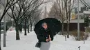 Saat menikmati salju, Aurel tampil cantik dengan outer hitam dan rok abu. Dia terlihat memakai payung agar tidak terkena salju secara langsung