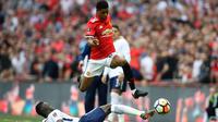 Penyerang Manchester United, Marcus Rashford berusaha melewati pemain Tottenham Hotspur, Davinson Sanchez saat bertanding pada semifinal Piala FA di stadion Wembley di London, (21/4). MU menang atas Tottenham 2-1. (AP Photo/Kirsty Wigglesworth)