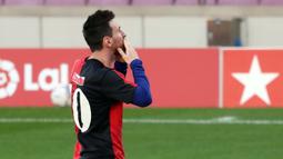 Striker Barcelona, Lionel Messi, menggunakan jersey Newell's Old Boys melakukan selebrasi saat melawan Osasuna pada laga Liga Spanyol di Stadion Camp Nou, Minggu (29/11/2020). Gol tersebut dipersembahkan untuk mendiang Diego Maradona. (AFP/J. Bassa)