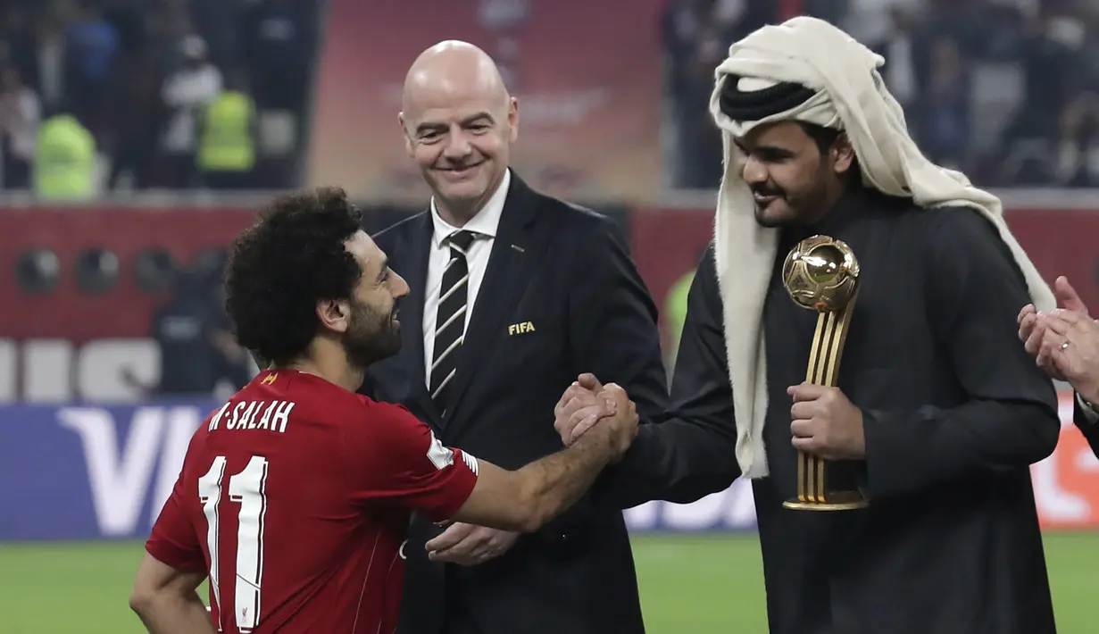 Presiden FIFA Gianni Infantino (tengah) menyaksikan Sheikh Joaan bin Hamad bin Khalifa Al Thani (kanan) berjabat tangan dengan penyerang Liverpool, Mohamed Salah setelah pertandingan antara Liverpool melawan Flamengo di Stadion Internasional Khalifa, Doha, Qatar (22/12/2019). (AP Photo/Hassan Ammar)
