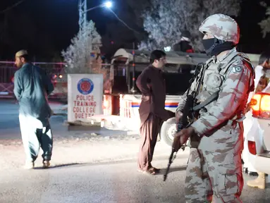 Tentara Pakistan berjaga dengan senjata lengkap di Akademi Polisi Balochistan, Quetta, Senin (24/10). Gerilyawan melakukan serangan di tempat tersebut yang mengakibatkan sedikitnya 59 orang tewas dan 117 luka parah. (AFP/Banaras Khan)