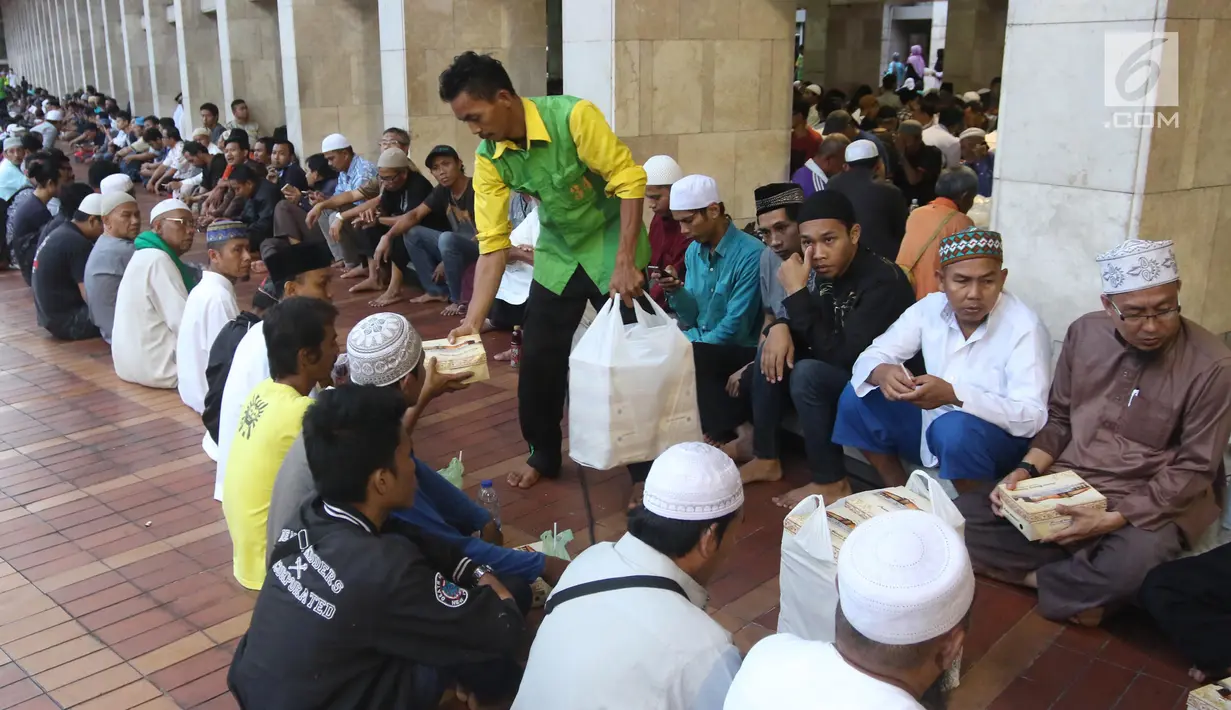 Panitia membagikan paket makanan kepada jemaah yang ingin buka puasa di Masjid Istiqlal, Jakarta, Kamis (17/5). (Liputan6.com/Arya Manggala)