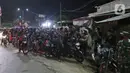 Pemudik menghentikan motornya di posko penyekatan mudik di Kedungwaringin, Kabupaten Bekasi, Jawa Barat, Minggu (9/5/2021). H-3 jelang Idul Fitri, petugas gabungan TNI, Polri, Dishub, dan Satpol PP memperketat penjagaan pemudik di perbatasan Kabupaten Bekasi-Karawang. (Liputan6.com/Herman Zakharia)