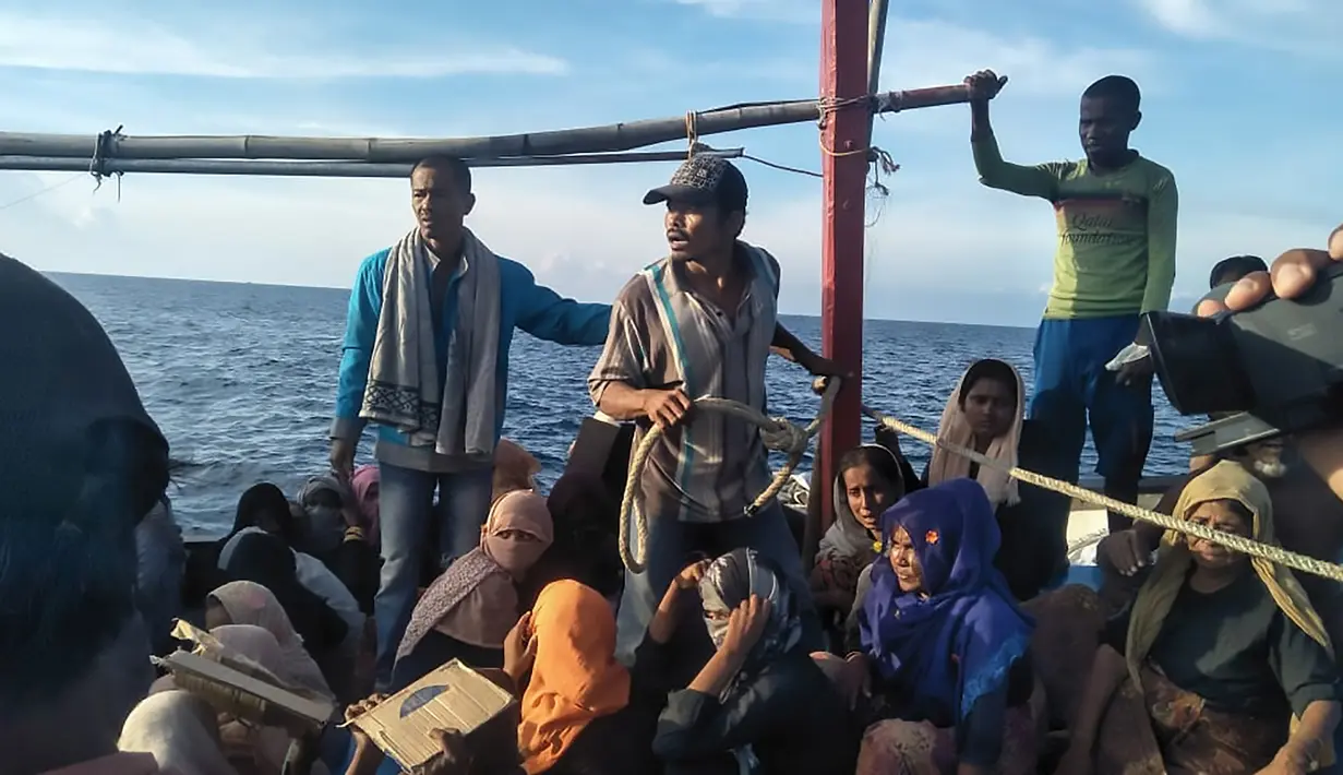 Pengungsi etnis Rohingya berada di atas kapal setelah terdampar di pesisir Pantai Seunuddon, Aceh Utara (24/6/2020). (INDONESIAN NAVY / AFP)
