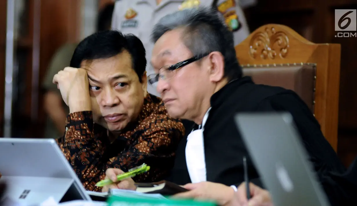 Terdakwa dugaan korupsi proyek e-KTP Setya Novanto (kanan) bersama kuasa hukumnya saat mengikuti sidang lanjutan di Pengadilan Tipikor, Jakarta, Kamis (11/1). Sidang mendengar keterangan empat orang saksi. (Liputan6.com/Helmi Fithriansyah)