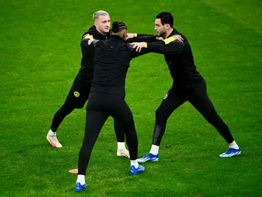 Penyerang Borussia Dortmund #11 Marco Reus (Kiri) dan #21 Donyell Malen (kanan) melakukan peregangan selama sesi latihan menjelang pertandingan Liga Champions di Stadion San Siro di Milan, Senin (27/11/2023). (MARCO BERTORELLO / AFP)