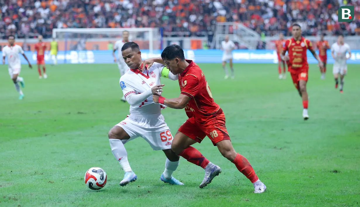 <p>Pemain Malut United, Manahati Lestusen, berebut bola dengan pemain Persija Jakarta, Eksel Runtukahu, pada laga pekan ke-3 BRI Super League di Jakarta International Stadium, Sabtu (23/8/2025) sore WIB. (Bola.com/M. Iqbal Ichsan)</p>