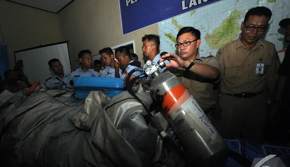  Salah satu petugas memeriksa tabung oksigen yang diduga bagian dari pesawat AirAsia QZ8501, Pangkalan Bun, Kalteng, Selasa (30/12/2014). (Liputan6.com/Miftahul Hayat)
