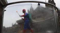 Pekerja sosial India Ashok Kurmi berpakaian seperti Spider Man mendesinfeksi daerah di sekitar stasiun kereta Chhatrapati Shivaji Maharaj selama lockdown yang diberlakukan di Mumbai, Rabu (21/4/2021). Kegiatan tersebut dilakukan untuk mengekang penyebaran COVID-19 di Mumbai. (AP Photo/Rajanish Kakad