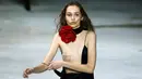 Seorang model berusaha merapikan gaun yang dikenakannya pada peragaan busana Yves Saint Laurent ready-to-wear di Paris, 28 Februari 2017. Gaun model tersebut melorot saat menampilkan koleksi Fall-Winter 2017-2018. (AP/Francois Mori)
