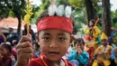 Wajah close up seorang murid TK Sekolah Alternatif untuk Anak Jalanan (SAAJA) saat mengenakan pakaian adat di kawasan Kuningan, Jakarta, Selasa (21/4/2015). Kegiatan tersebut dalam rangka memperingati Hari Kartini. (Liputan6.com/Faizal Fanani)