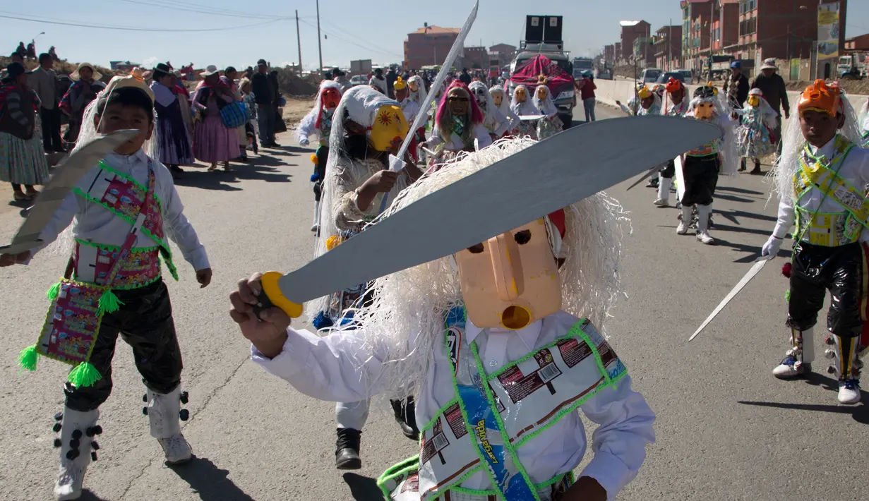 Siswa mengenakan topeng dari wadah minyak goreng plastik sambil menari "Paquchi" pada festival di Bolivia, Selasa (14/8). Siswa sekolah San Roque membuat kostum dari bahan daur ulang untuk meningkatkan kesadaran pengelolaan limbah padat. (AP/Juan Karita)