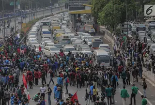 Massa mahasiswa memblokade Tol Dalam Kota saat berunjuk rasa di depan Gedung DPR/ MPR RI, Jakarta, Selasa (24/9/2019). Unjuk rasa menuntut penolakan atas pengesahan sejumlah RUU kontroversial tersebut diwarnai aksi bakar sejumlah kardus di tol dalam kota. (Liputan6.com/Faizal Fanani)
