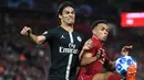 Striker Paris Saint-Germain (PSG), Edinson Cavani (kiri) berebut bola dengan bek Liverpool Trent Alexander-Arnold saat bertanding di Liga Champions di Anfield, Liverpool, Inggris, Selasa (18/9). Liverpool membungkam PSG 3-2. (Paul ELLIS/AFP)