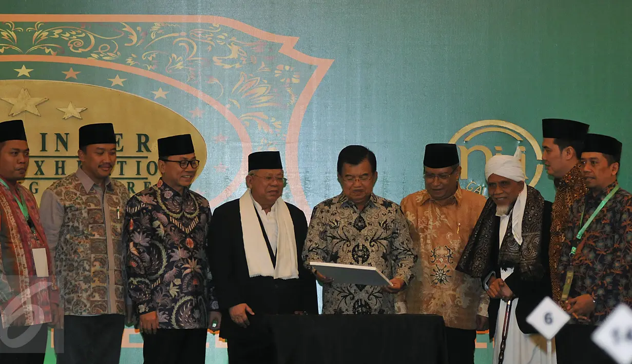 Wapres Jusuf Kalla disaksikan Ketua PBNU Said Aqil Siroj (ketiga kanan) usai menandatangani kartu NU Care pada acara peluncuran di Jakarta, Kamis (25/2). NU Care memberikan kemudahaan pada masyarakat untuk berzakat dengan tertib. (Liputan6.com/JohanTallo)